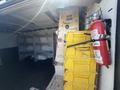 A 2017 Chevrolet Express van interior showing yellow storage bins secured to the wall and a red fire extinguisher mounted nearby