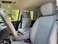 Interior of a 2013 RAM 2500 showing the front seats and console with grey upholstery and armrest