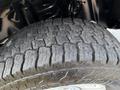 Close-up of a rugged tire tread from a 2021 Ford F-350 SD showcasing deep grooves and a sturdy design suitable for off-road conditions
