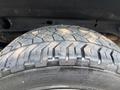A close-up of a tire with an intricate tread pattern mounted on a 2017 Chevrolet Silverado 1500