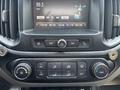 Dashboard control panel of a 2017 Chevrolet Colorado featuring climate control dials and a touchscreen display for audio and radio settings