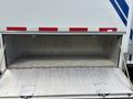 A 1994 GMC Vandura 3500 with an open side cargo compartment revealing a spacious metallic interior with a textured floor and two metal hatches.