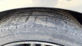 Close-up of a worn tire on a 2018 Hyundai Sonata showing visible tread wear and debris on the tire surface