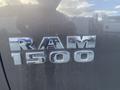 A close-up of the chrome RAM 1500 emblem on a truck's side panel