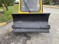 A 2004 Bombardier SW48 snowplow blade featuring a wide curved metal surface with a series of holes along the edge for attachment and a flat bottom for clearing snow
