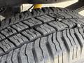 A close-up of a tire from a 2008 Ford F-250 SD showcasing the tread pattern and surface detail of the rubber