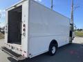 A white 2012 Ford Econoline cargo van with a closed rear door and no visible branding or markings