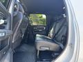 A 2018 RAM 3500 showing the interior of the back seat with leather seats and a spacious layout