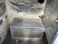 A metal storage compartment with a perforated front surface inside a vehicle interior