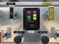 Control panel of a 1999 Freightliner FL80 featuring buttons for foam pressure monitor engine cooler and pump cooler indicators