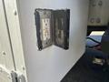 An electrical outlet with a cover on the side of a 2005 Freightliner M2 106 truck