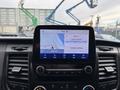 Dashboard display of a 2020 Ford Transit 250 showing radio station details and navigation information