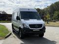 A 2017 Mercedes-Benz Sprinter van with a white exterior and black accents parked with its front facing the viewer