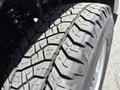 Close-up of a tread pattern on a tire of a 2011 Chevrolet Colorado showing deep grooves and rugged design for traction on various surfaces