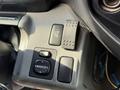 Controls on the dashboard of a 2014 Hino 195 including buttons for heated mirrors and a directional mirror adjustment knob