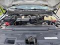 View of the engine bay of a 2018 Ford F-350 displaying the engine components battery and coolant reservoir