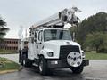 A 2013 Freightliner 114SD truck with a white body and a mounted aerial lift system on top