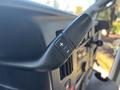 Close-up of the control lever inside a 2020 Chevrolet Express featuring buttons for increasing and decreasing settings