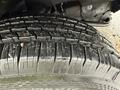 A close-up view of a tire tread from a 2013 Chevrolet Express showing deep grooves and patterns for traction
