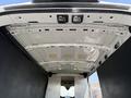 Interior view of a 2022 Ford Transit van showing the white ceiling and metal framework of the cargo area
