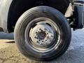 Close-up of a front tire on a 2010 Ford F-450 featuring a Michelin tire and steel wheel with visible lug nuts