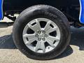 Close-up of a silver wheel with five spokes and a Chevrolet emblem on a 2017 Chevrolet Colorado tire labeled Advantage T/A