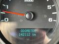 Close-up of the odometer in a 2013 Chevrolet Silverado 1500 displaying 142112 km