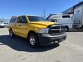 A yellow 2015 RAM 1500 pickup truck is displayed prominently in the foreground with chrome wheels and a black grille