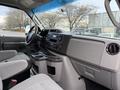 Interior view of a 2022 Ford E-450 showing the dashboard control panel center console and seating area
