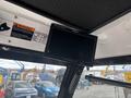 A black monitor mounted on the ceiling displaying vehicle information in a 2019 Madvac LS175 with various controls and warning labels visible around it