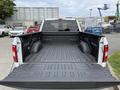 A 2018 Ford F-150 truck with an open bed showcasing a rugged, textured liner and side compartments