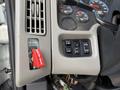 Control panel of a 2011 International 7500 featuring buttons for emergency shutoff and various functions