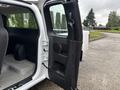 A 2011 Chevrolet Colorado with the passenger side door open revealing the interior and seating area