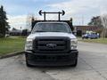 Front view of a 2015 Ford F-350 truck with a black grille and yellow lights on the roof