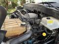 Close-up of a 2012 International DuraStar 4300 engine showing various components including hoses a coolant reservoir and an engine block