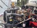 A 1999 Freightliner FL80 engine with visible components including hoses wires and metal parts arranged in a complex configuration