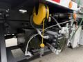 A 2016 Peterbilt 348 featuring hydraulic components including a black pump and a yellow pulley system with a visible cable attachment
