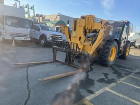 A 2013 JCB 510-56 Loadall with a yellow and black frame features large wheels and a front-mounted forklift attachment with extended prongs