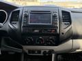 Interior dashboard of a 2013 Toyota Tacoma featuring a control panel with audio system display and climate control knobs