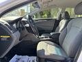 Interior view of a 2015 Hyundai Sonata featuring gray seats and a modern dashboard with controls and a steering wheel