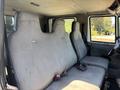 Interior of a 2011 International 4300 featuring two large fabric-covered seats with seatbelts and a spacious cabin layout