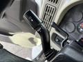 A close-up of the turn signal lever inside a 2012 International DuraStar 4300 featuring various control settings and labeled markings