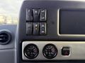 Dashboard controls of a 2022 Lion Lion6 featuring various buttons and two circular gauges displaying temperature readings
