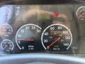 A close-up view of a 2011 Freightliner B2 dashboard featuring gauges for RPM speed fuel oil temperature and voltmeter with a digital odometer reading 48623.6 km