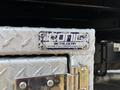 A silver metal toolbox with a diamond plate pattern featuring a blue and white logo that reads "ICONIC METALGEAR" and includes a phone number and website