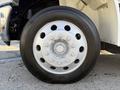 A close-up view of a silver wheel with multiple lug nuts mounted on a tire for a 2017 International 4300 truck