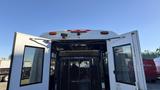A white 2021 Ford Transit with a rear open door reveals a spacious interior and a metal safety partition