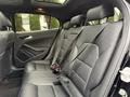 The interior of a 2016 Mercedes-Benz GLA-250 showing black leather rear seats with seatbelts and headrests
