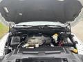 A 2016 RAM 1500 engine bay featuring the exposed engine block battery coolant reservoir and various engine components with the hood lifted