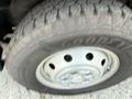 Close-up of a tire on a 2017 RAM Promaster showing the metallic wheel rim and the textured tread of the tire